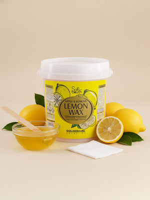 Container of lemon wax with lemons and a wooden applicator on a beige background