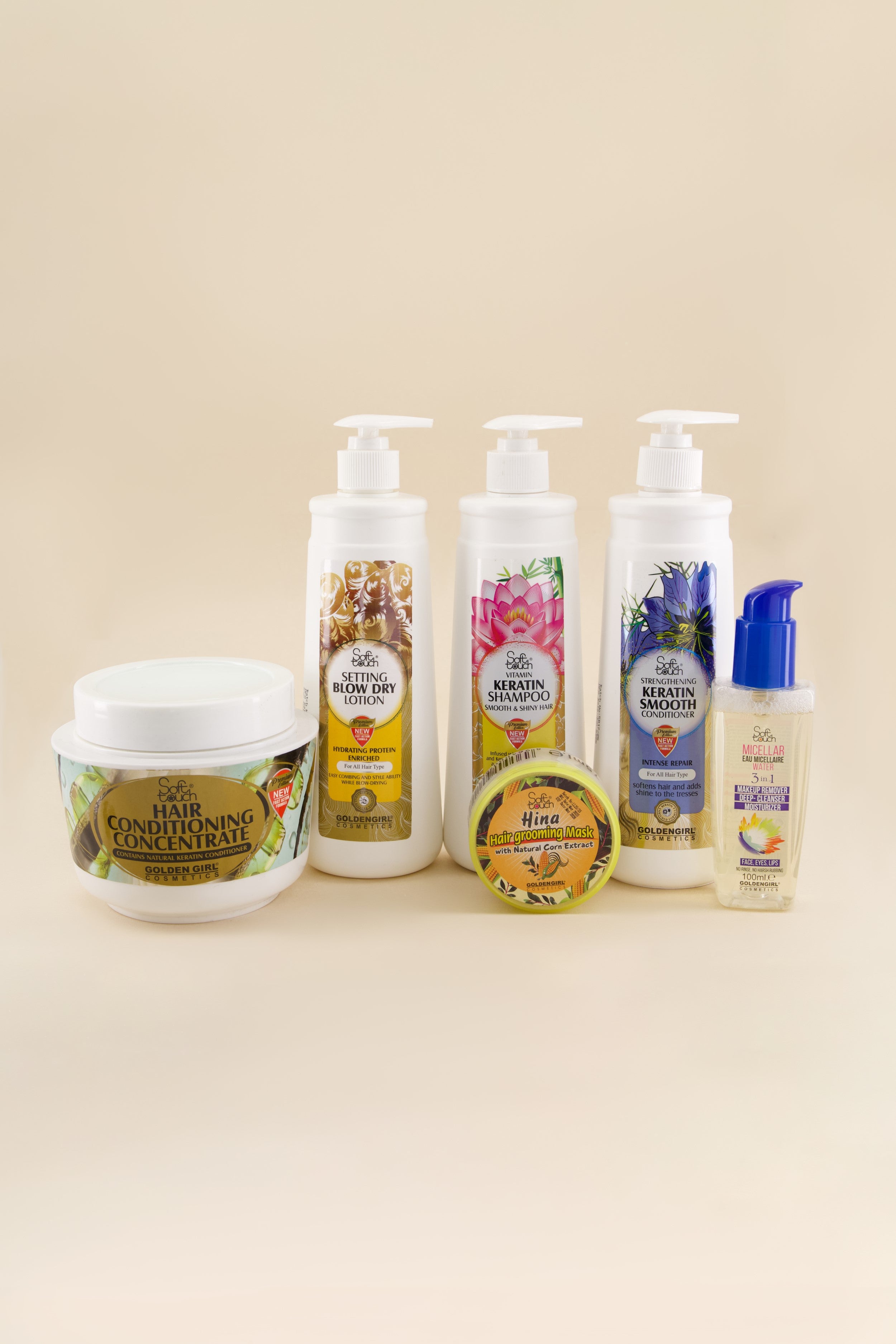 Collection of hair care products on a beige background