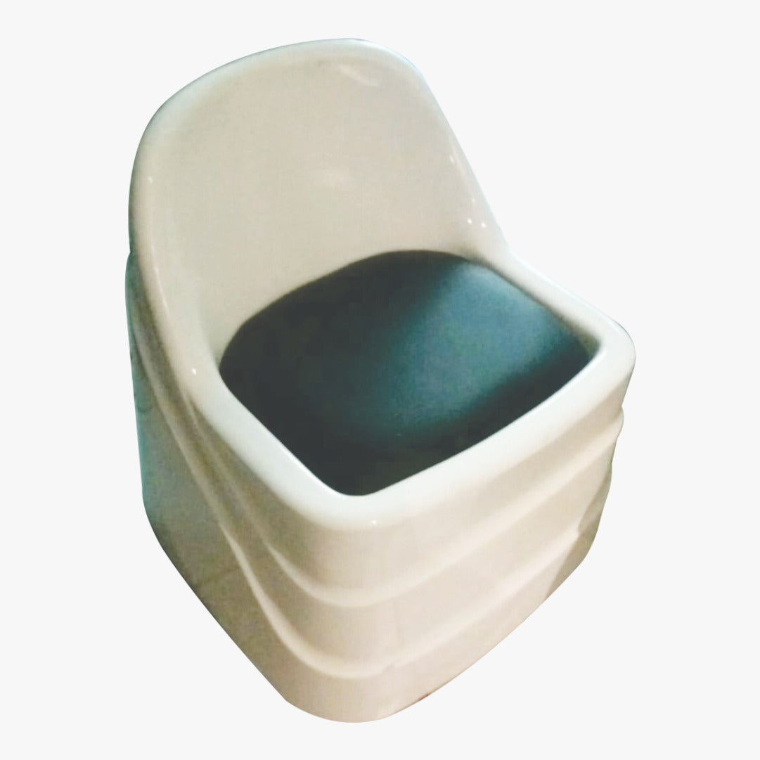 A white pedicure chair with a black cushion, designed for spa use.