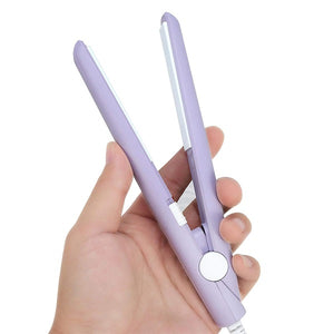 A small handheld mini hair straightener in a purple color being held in a person's hand.