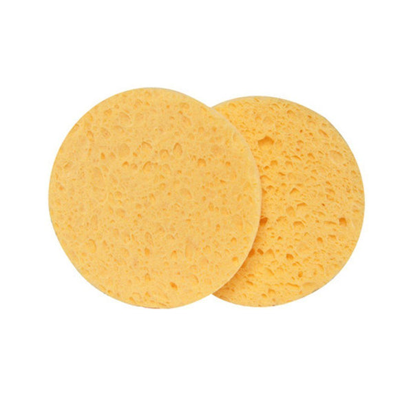 Two yellow facial sponges, round in shape, displayed against a white background.